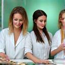 Three professional Austin wellness experts reviewing product samples in a bright, modern lab setting.
